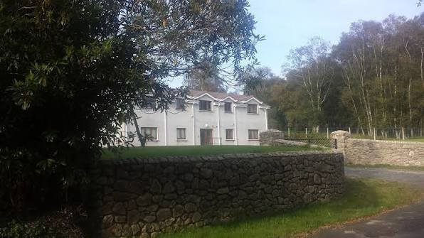 The Annamoe Centre, behind a stone wall among the trees