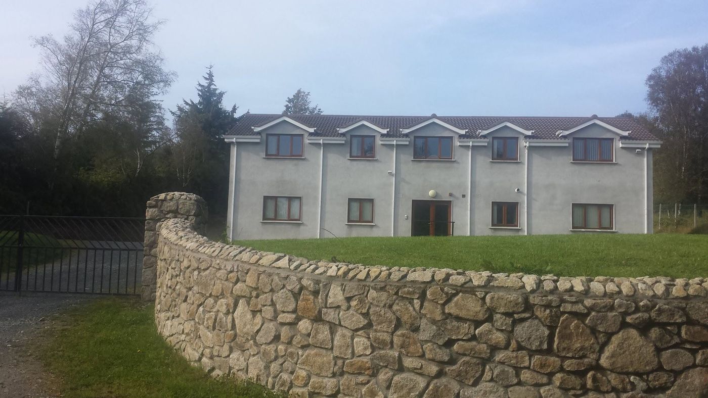 Our den, the Annamoe Centre, behind its curved granite wall