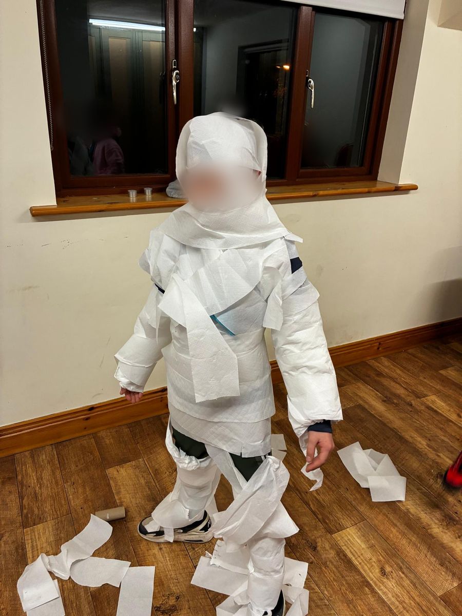 A Cub wrapped from head to toe in toilet paper as a Halloween mummy